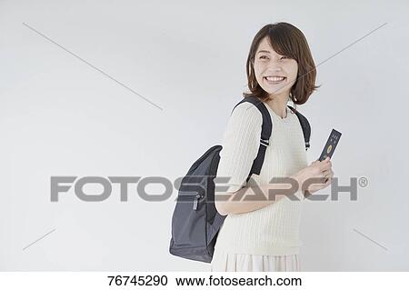 Young Japanese woman against white wall View Large Photo Image Stock Image - Young Japanese woman against white wall. Fotosearch