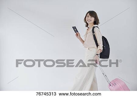 Young Japanese woman against white wall View Large Photo Image Stock Image - Young Japanese woman against white wall. Fotosearch