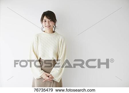 Young Japanese woman against white wall View Large Photo Image Stock Photo - Young Japanese woman against white wall. Fotosearch