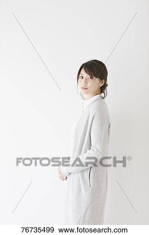 Stock Photo - Young Japanese woman against white wall. Fotosearch