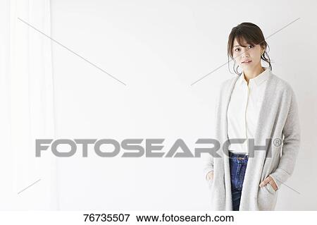 Stock Photo - Young Japanese woman against white wall. Fotosearch
