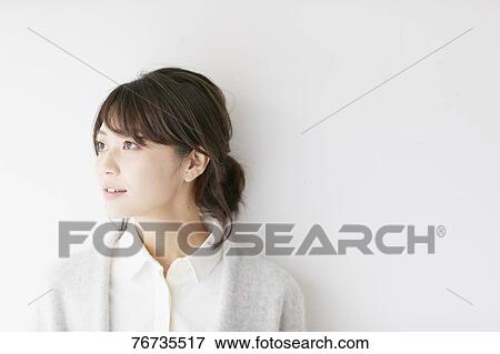Young Japanese woman against white wall View Large Photo Image Stock Photo - Young Japanese woman against white wall. Fotosearch