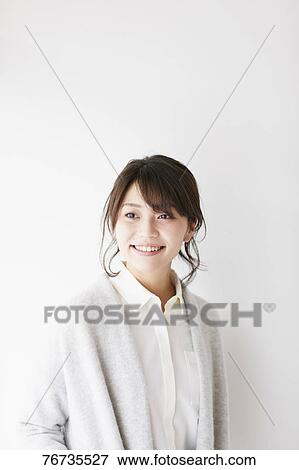 Young Japanese woman against white wall View Large Photo Image Stock Photo - Young Japanese woman against white wall. Fotosearch