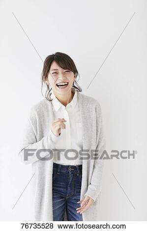 Stock Photo - Young Japanese woman against white wall. Fotosearch