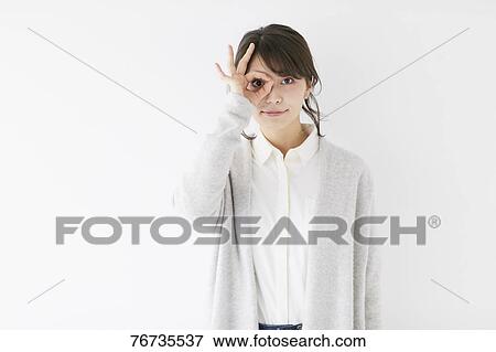 Stock Photo - Young Japanese woman against white wall. Fotosearch
