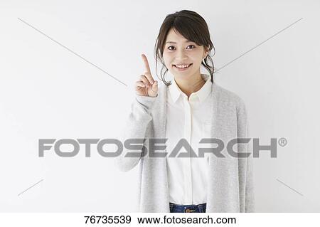 Stock Photo - Young Japanese woman against white wall. Fotosearch