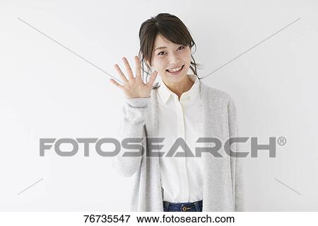 Stock Photo - Young Japanese woman against white wall. Fotosearch