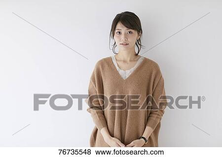 Young Japanese woman against white wall View Large Photo Image Stock Photo - Young Japanese woman against white wall. Fotosearch