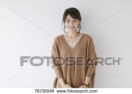 Stock Photo - Young Japanese woman against white wall. Fotosearch