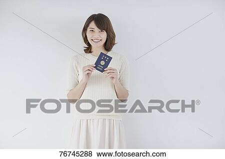 Stock Photo - Young Japanese woman against white wall. Fotosearch