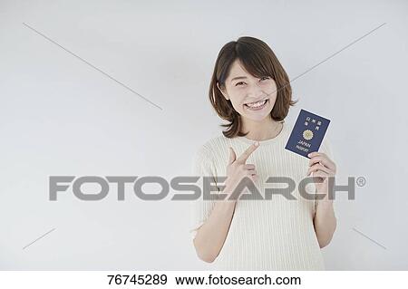 Young Japanese woman against white wall View Large Photo Image Stock Photo - Young Japanese woman against white wall. Fotosearch