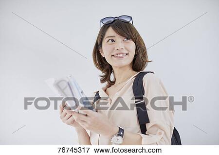 Young Japanese woman against white wall View Large Photo Image Stock Photo - Young Japanese woman against white wall. Fotosearch