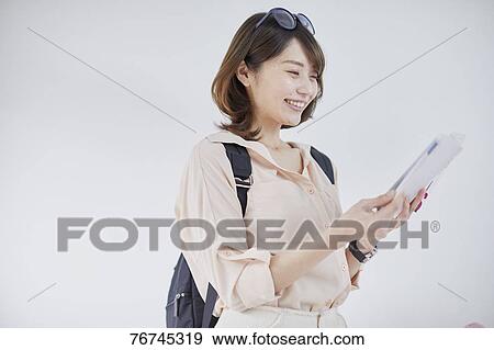 Young Japanese woman against white wall View Large Photo Image Stock Photo - Young Japanese woman against white wall. Fotosearch