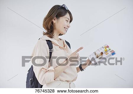 Stock Photo - Young Japanese woman against white wall. Fotosearch