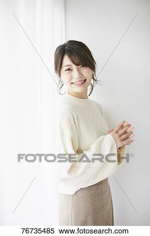 Young Japanese woman against white wall View Large Photo Image Stock Photography - Young Japanese woman against white wall. Fotosearch