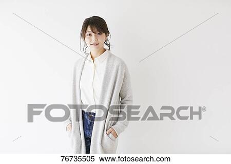 Stock Photography - Young Japanese woman against white wall. Fotosearch