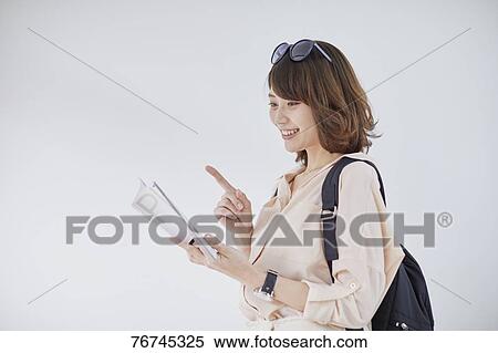 Young Japanese woman against white wall View Large Photo Image Stock Photography - Young Japanese woman against white wall. Fotosearch