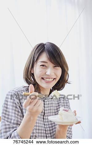 Young Japanese woman eating cake View Large Photo Image Picture - Young Japanese woman eating cake. Fotosearch