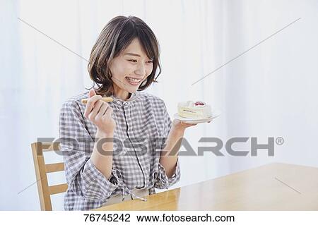 Young Japanese woman eating cake View Large Photo Image Stock Image - Young Japanese woman eating cake. Fotosearch