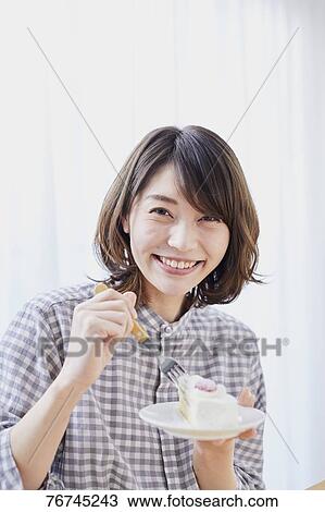 Young Japanese woman eating cake View Large Photo Image Stock Image - Young Japanese woman eating cake. Fotosearch