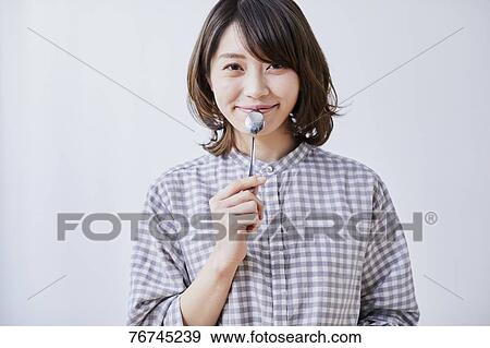 Young Japanese woman eating cake View Large Photo Image Stock Photo - Young Japanese woman eating cake. Fotosearch