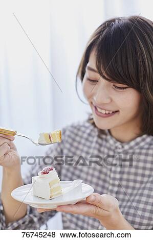 Young Japanese woman eating cake View Large Photo Image Stock Photo - Young Japanese woman eating cake. Fotosearch