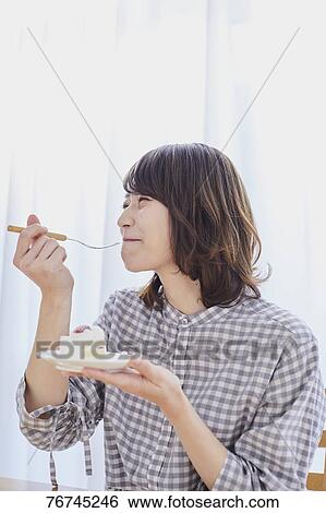 Young Japanese woman eating cake View Large Photo Image Stock Photograph - Young Japanese woman eating cake. Fotosearch