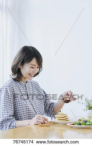 Young Japanese woman eating pancakes View Large Photo Image Picture - Young Japanese woman eating pancakes. Fotosearch