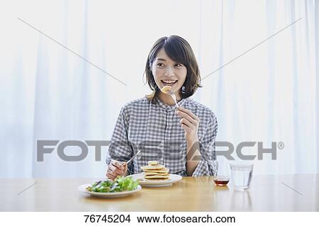 Young Japanese woman eating pancakes View Large Photo Image Picture - Young Japanese woman eating pancakes. Fotosearch
