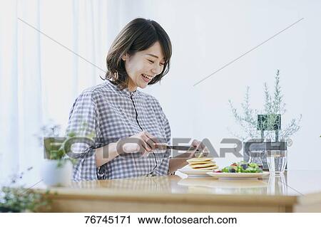 Young Japanese woman eating pancakes View Large Photo Image Stock Image - Young Japanese woman eating pancakes. Fotosearch