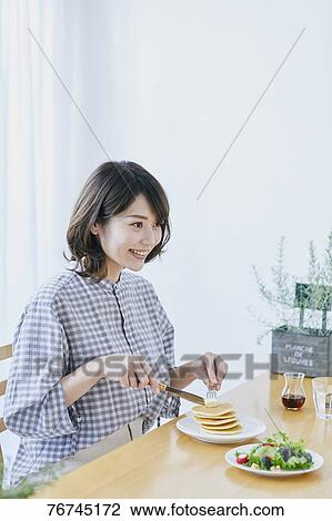Young Japanese woman eating pancakes View Large Photo Image Stock Image - Young Japanese woman eating pancakes. Fotosearch