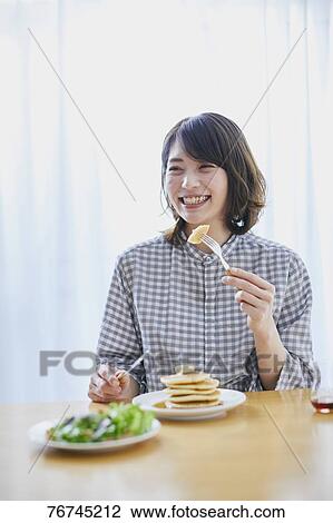 Young Japanese woman eating pancakes View Large Photo Image Stock Image - Young Japanese woman eating pancakes. Fotosearch