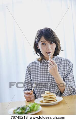 Young Japanese woman eating pancakes View Large Photo Image Stock Image - Young Japanese woman eating pancakes. Fotosearch