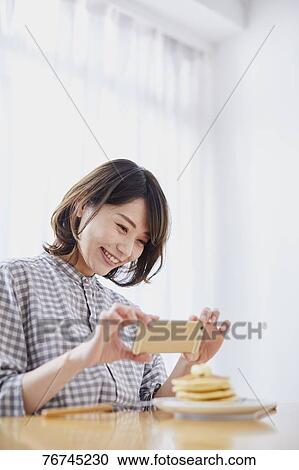 Young Japanese woman eating pancakes View Large Photo Image Stock Image - Young Japanese woman eating pancakes. Fotosearch