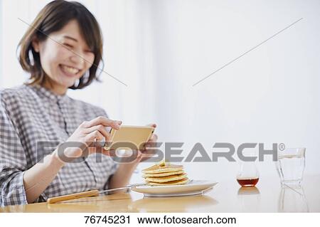 Young Japanese woman eating pancakes View Large Photo Image Stock Image - Young Japanese woman eating pancakes. Fotosearch