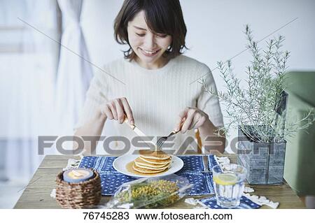 Young Japanese woman eating pancakes View Large Photo Image Stock Image - Young Japanese woman eating pancakes. Fotosearch