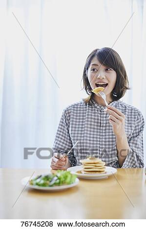 Young Japanese woman eating pancakes View Large Photo Image Stock Photo - Young Japanese woman eating pancakes. Fotosearch