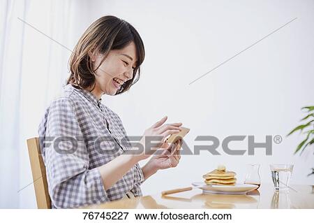 Young Japanese woman eating pancakes View Large Photo Image Stock Photo - Young Japanese woman eating pancakes. Fotosearch