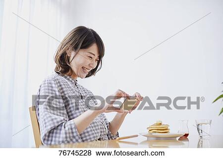 Young Japanese woman eating pancakes View Large Photo Image Stock Photo - Young Japanese woman eating pancakes. Fotosearch