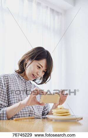 Young Japanese woman eating pancakes View Large Photo Image Stock Photo - Young Japanese woman eating pancakes. Fotosearch