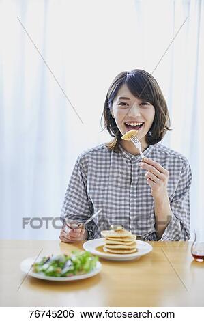 Young Japanese woman eating pancakes View Large Photo Image Stock Photograph - Young Japanese woman eating pancakes. Fotosearch