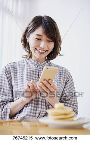 Young Japanese woman eating pancakes View Large Photo Image Stock Photography - Young Japanese woman eating pancakes. Fotosearch