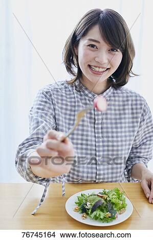 Young Japanese woman eating salad View Large Photo Image Picture - Young Japanese woman eating salad. Fotosearch