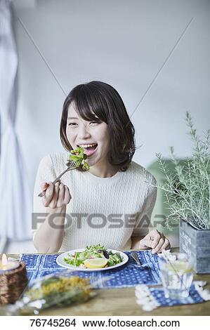 Young Japanese woman eating salad View Large Photo Image Picture - Young Japanese woman eating salad. Fotosearch