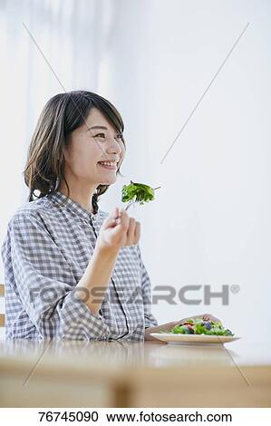 Young Japanese woman eating salad View Large Photo Image Stock Image - Young Japanese woman eating salad. Fotosearch
