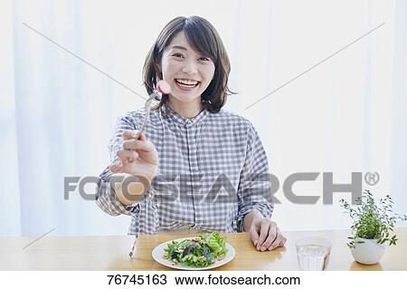 Young Japanese woman eating salad View Large Photo Image Stock Image - Young Japanese woman eating salad. Fotosearch