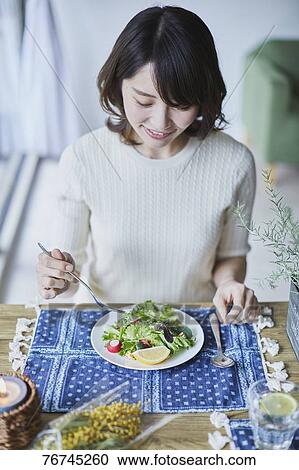Young Japanese woman eating salad View Large Photo Image Stock Image - Young Japanese woman eating salad. Fotosearch