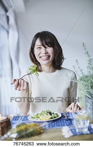 Young Japanese woman eating salad View Large Photo Image Stock Image - Young Japanese woman eating salad. Fotosearch