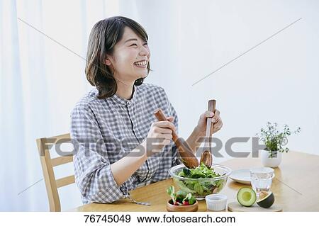 Young Japanese woman eating salad View Large Photo Image Stock Photo - Young Japanese woman eating salad. Fotosearch