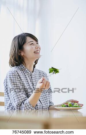 Young Japanese woman eating salad View Large Photo Image Stock Photo - Young Japanese woman eating salad. Fotosearch
